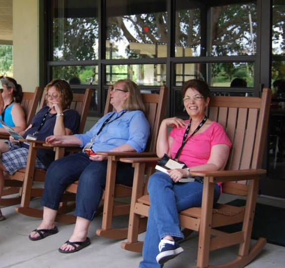 Women enjoy rocking chairs at the women's retreat